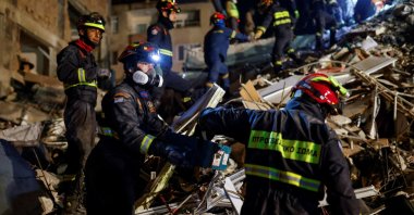 Members of a Greek rescue team work on the site of a collapsed building as the search for survivors continues in the aftermath of a deadly earthquake, Hatay, southern Türkiye, Feb. 11, 2023. (Reuters Photo)