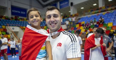 Cemal Kütahya, the captain of Türkiye's national handball team and his son, Çınar, smile after a game in this undated photo released on Feb. 13, 2023. (DHA File Photo)