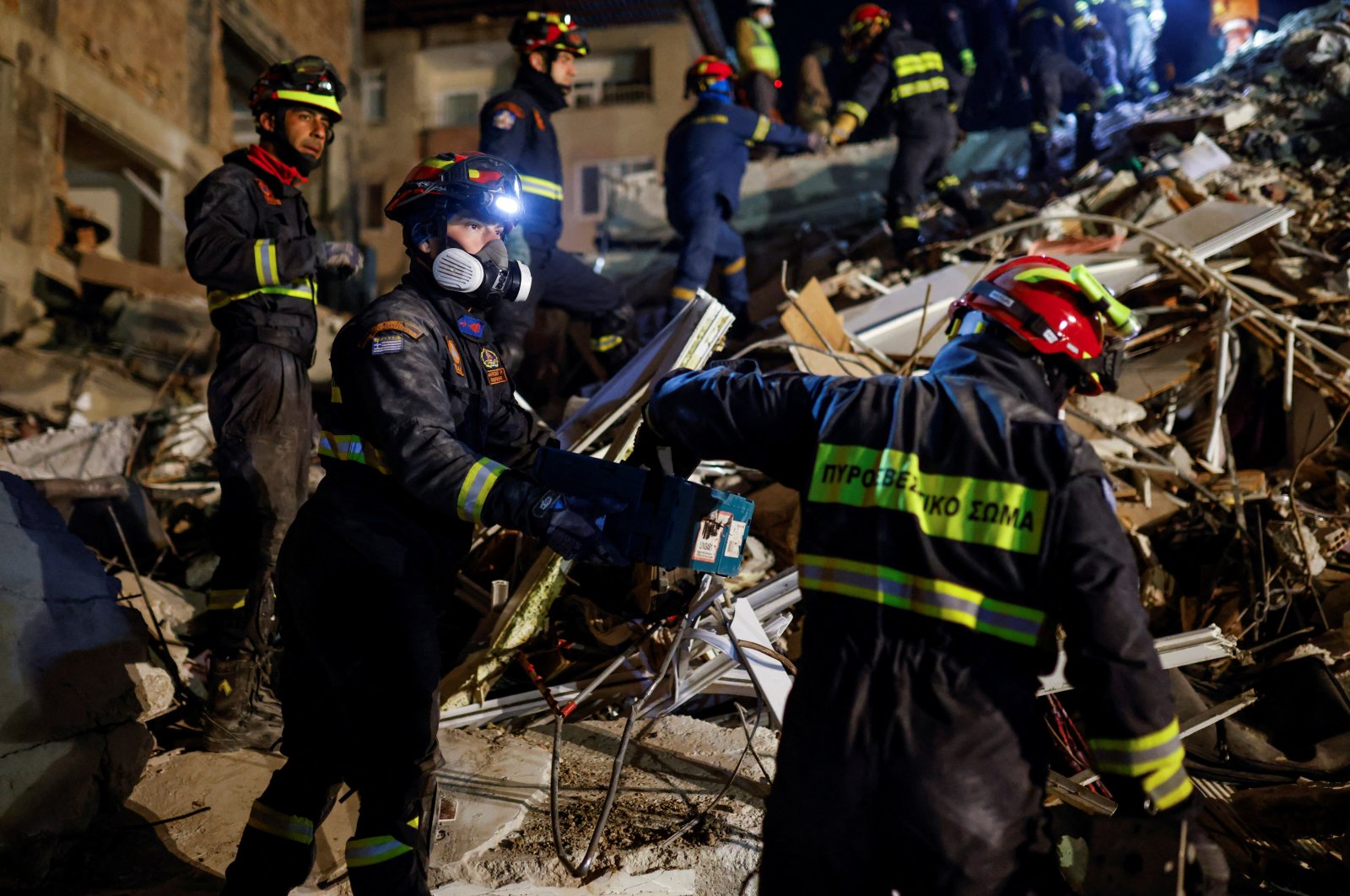 Members of a Greek rescue team work on the site of a collapsed building as the search for survivors continues in the aftermath of a deadly earthquake, Hatay, southern Türkiye, Feb. 11, 2023. (Reuters Photo)