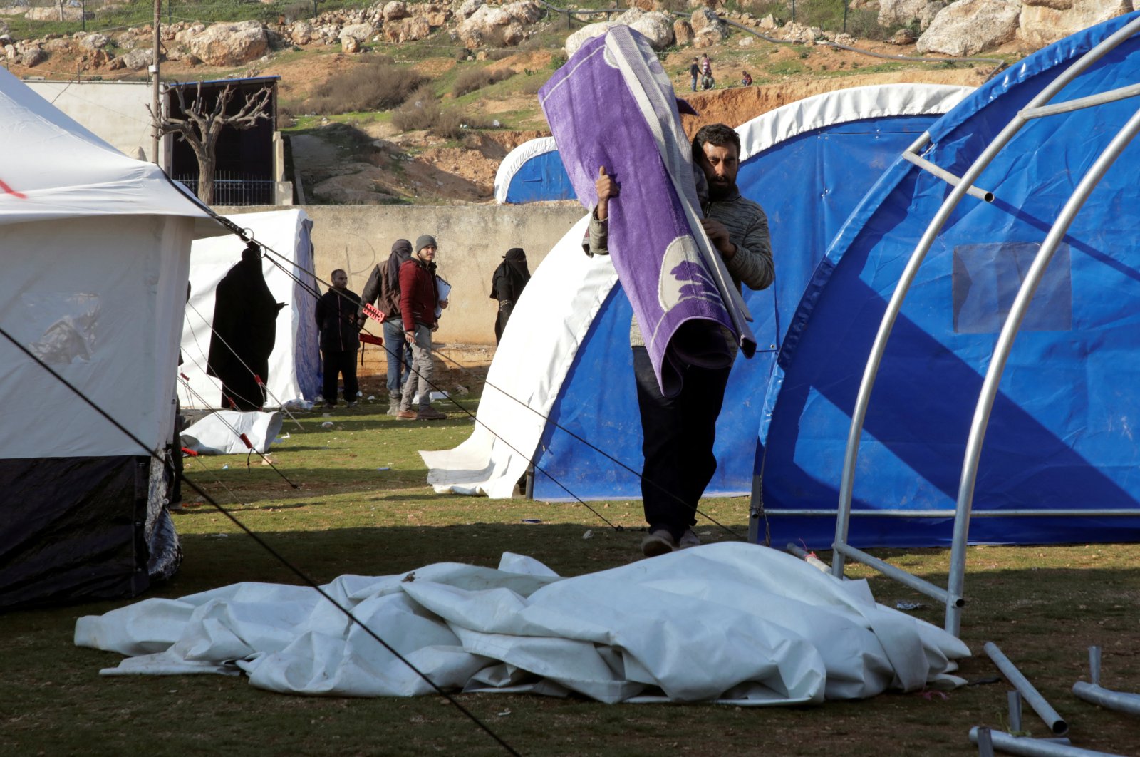 Displaced Syrians who lost their homes during the earthquake set up tents in a schoolyard, Harem, northwestern Syria, Feb. 13, 2023. (Reuters Photo)