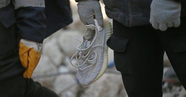 A shoe believed to belong to Hatayspor&#039;s Ghanaian football player Christian Atsu during search and rescue efforts in the wreckage of the Rönesans Residence, Hatay, Türkiye, Feb. 15, 2023. (AA Photo)