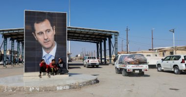 A picture of Syria's Bashar Assad is seen on a road where vehicles containing aid head to Syria to support earthquake victims, al-Tanf, Syria, Feb. 12, 2023. (Reuters Photo)