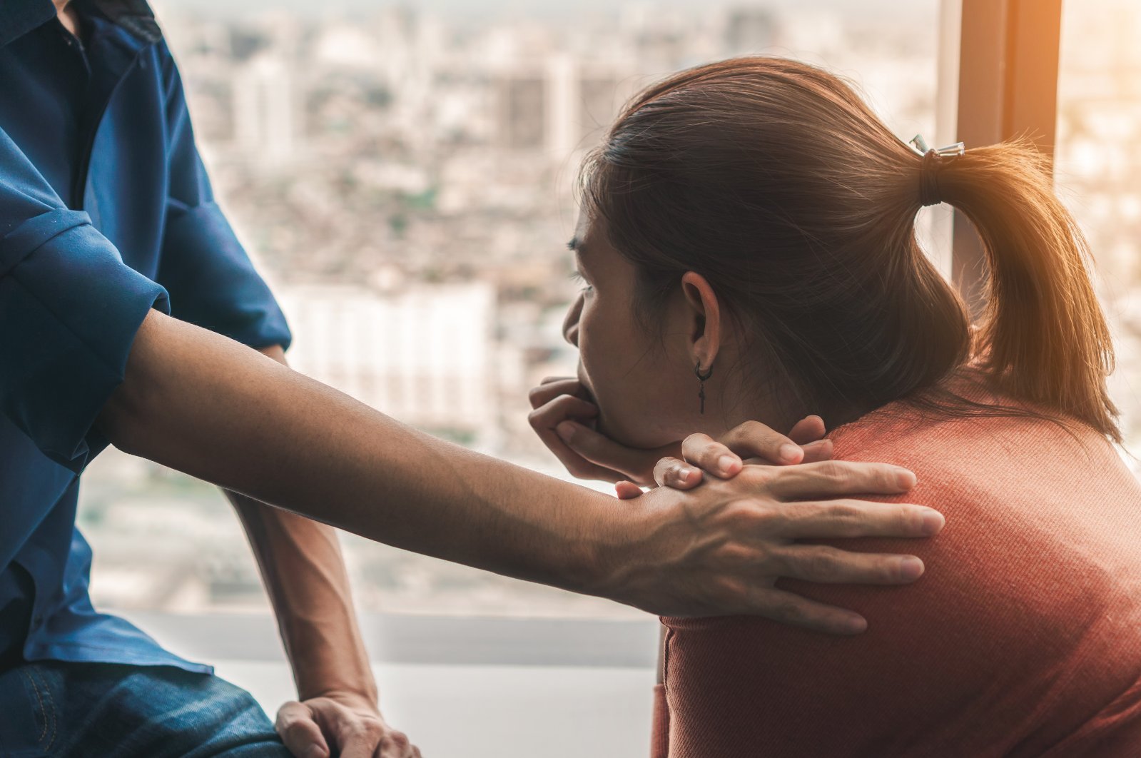 A psychologist provides consolation for a woman with signs of post-traumatic stress disorder (PTSD). (Shutterstock Photo)