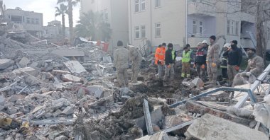 Rescue teams are seen on the site of a destroyed building in the Arsuz district in Hatay, Feb. 8, 2023. (AA File Photo)