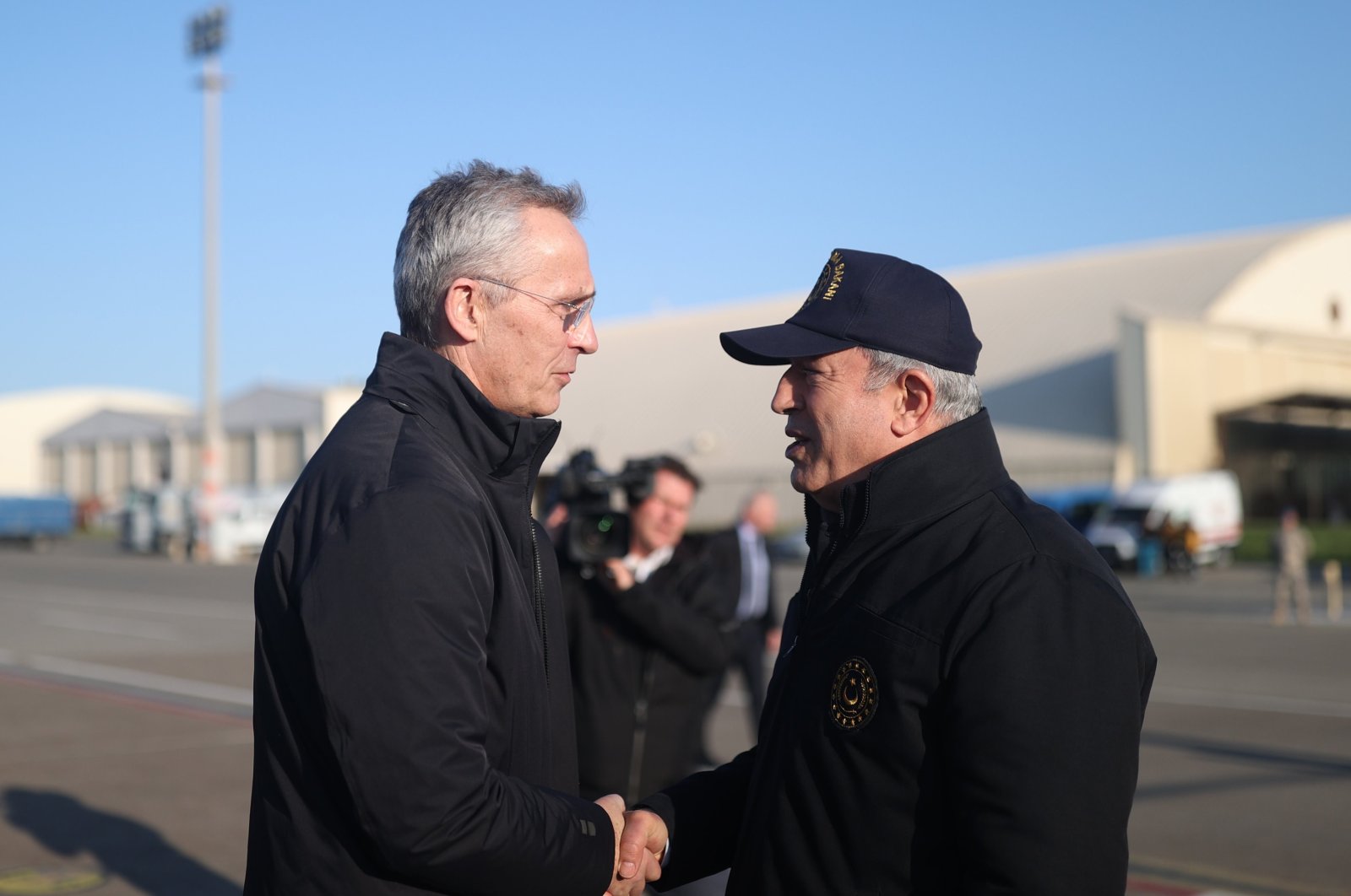 Defense Minister Hulusi Akar (R), and NATO chief Jens Stoltenberg (L) shake hands in Hatay, Türkiye, Feb. 16, 2023. (IHA Photo)