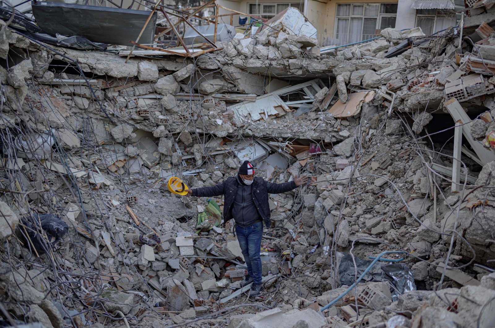 A man stands amid the rubble of a collapsed building after the deadly earthquake in Antakya, south of Hatay province, Türkiye, Feb. 15, 2023. (AFP Photo)