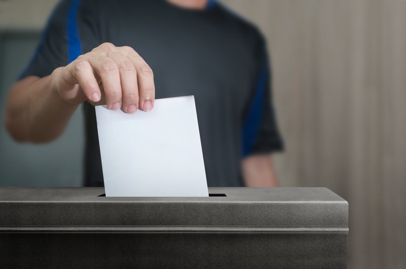 Man holds a ballot for elections at an unspecified location in this undated file photo. (Shutterstock File Photo)