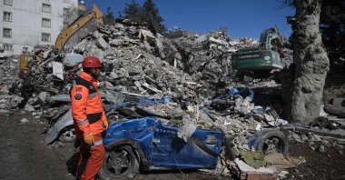 A rescuer stands in front of rubble near the site where Aleyna Ölmez, 17, was rescued from a collapsed building, 248 hours after the 7.7 magnitude earthquake struck parts of Türkiye and Syria, in Kahramanmaraş, Türkiye, Feb. 16, 2023. (AFP Photo)