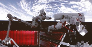 In this photo released by Xinhua News Agency, a video screen shows Chinese astronaut Fei Junlong conducting extravehicular activities on the orbiting Tiangong space station, Feb. 9, 2023. (AP Photo)