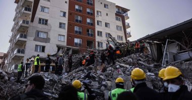 Rescue personnel search for bodies of victims under the rubble of a collapsed building in Antakya, Türkiye, Feb. 18, 2023. (AFP Photo)