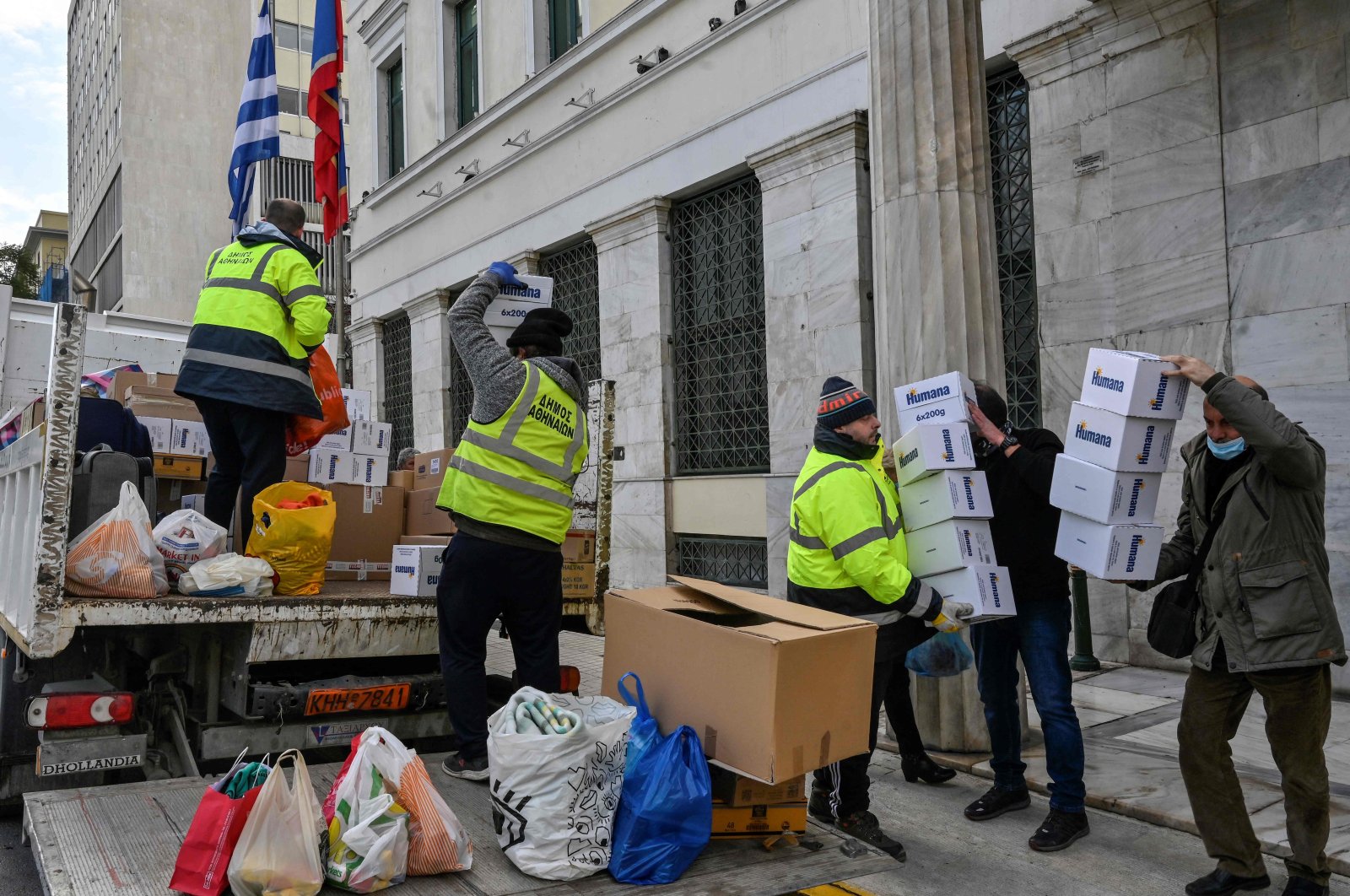 Municipal workers load a truck with humanitarian aid outside of the municipality of Athens, Greece, Feb. 10, 2023. (AFP Photo)