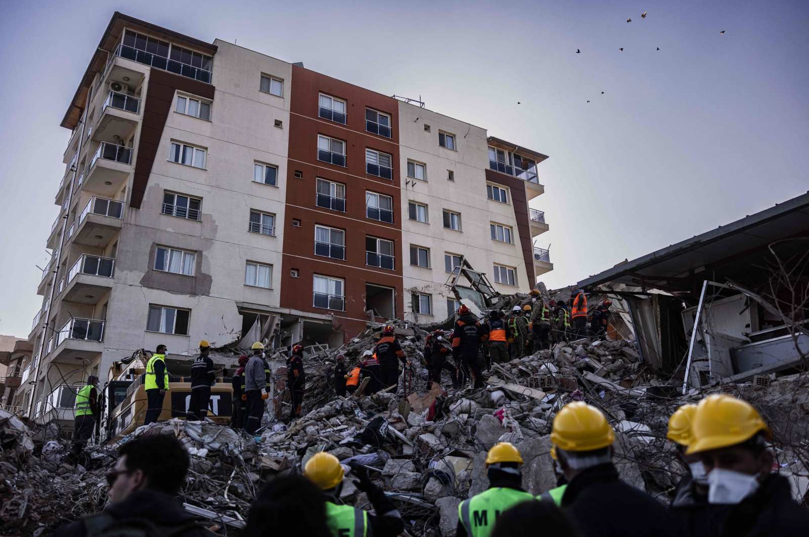 Rescue personnel search for bodies of victims under the rubble of a collapsed building in Antakya, Türkiye, Feb. 18, 2023. (AFP Photo)