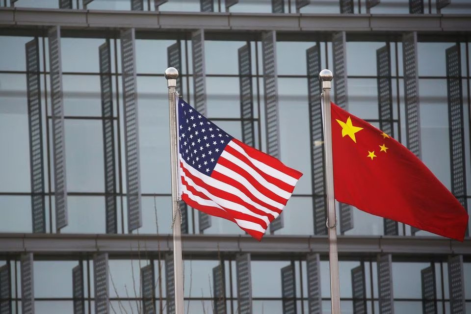 Chinese and U.S. flags flutter outside the building of an American company in Beijing, China, Jan. 21, 2021. (Reuters Photo)