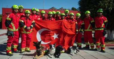 Mexican search and rescue team, who came to Türkiye after the earthquakes that hit 10 cities in the south of the country, poses with the Turkish flag, Feb. 18, 2023. (AA Photo)