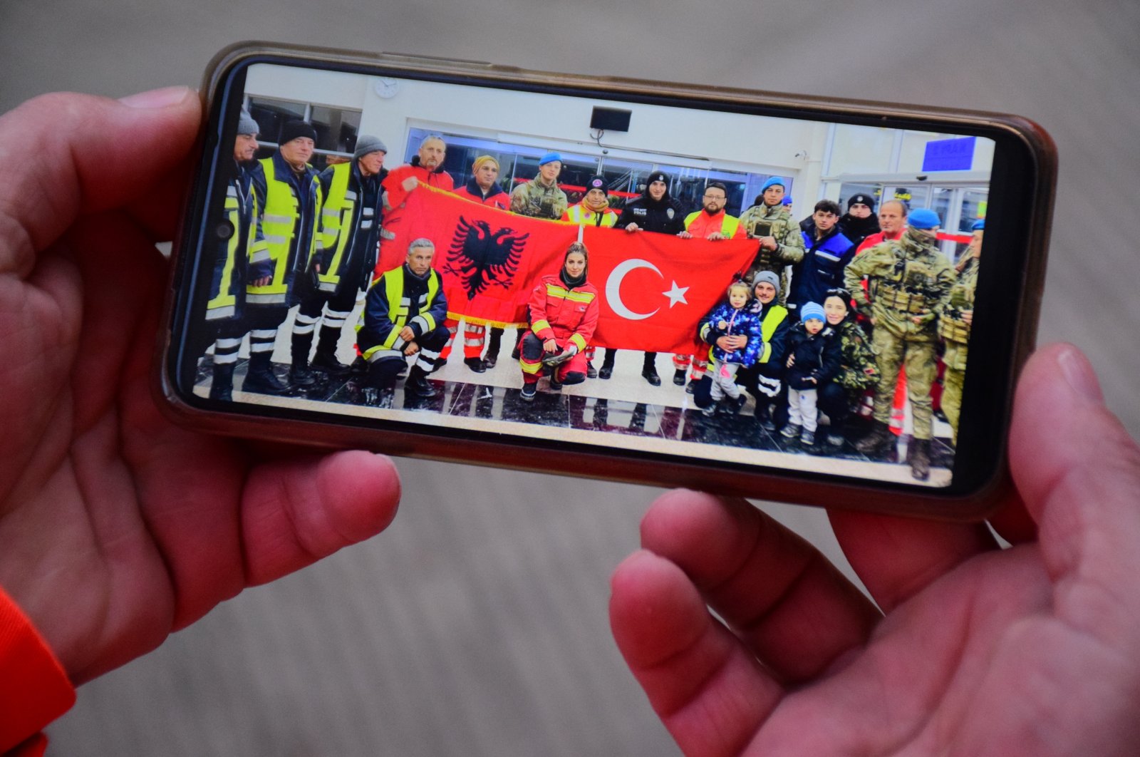 A volunteer with the Albanian rescue team shows a photo on his mobile phone ahead of their return to their country during an interview with Anadolu Agency (AA) recounting the team&#039;s experience in earthquake-stricken Türkiye, Feb. 15, 2023. (AA Photo)