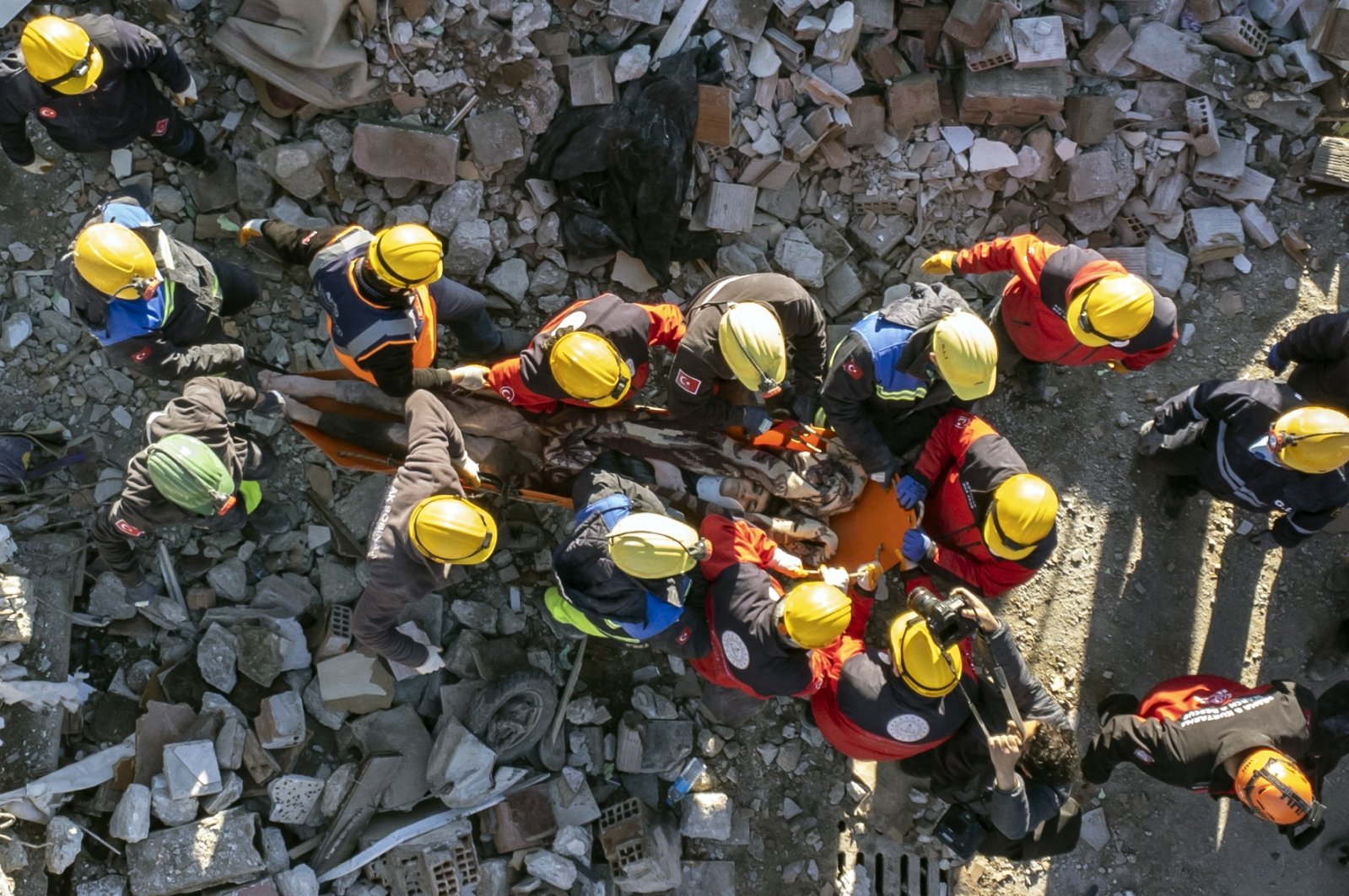 Rescuers carry a survivor who was pulled from under a collapsed building, 60 hours after an earthquake, in Hatay, Türkiye, Feb. 8, 2023. (EPA Photo)