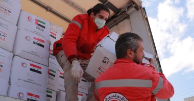 Syrian Arab Red Crescent personnel carry boxes of aid offered by the United Arab Emirates in response to a deadly earthquake, in Latakia, Syria, Feb. 15, 2023. (Reuters Photo)