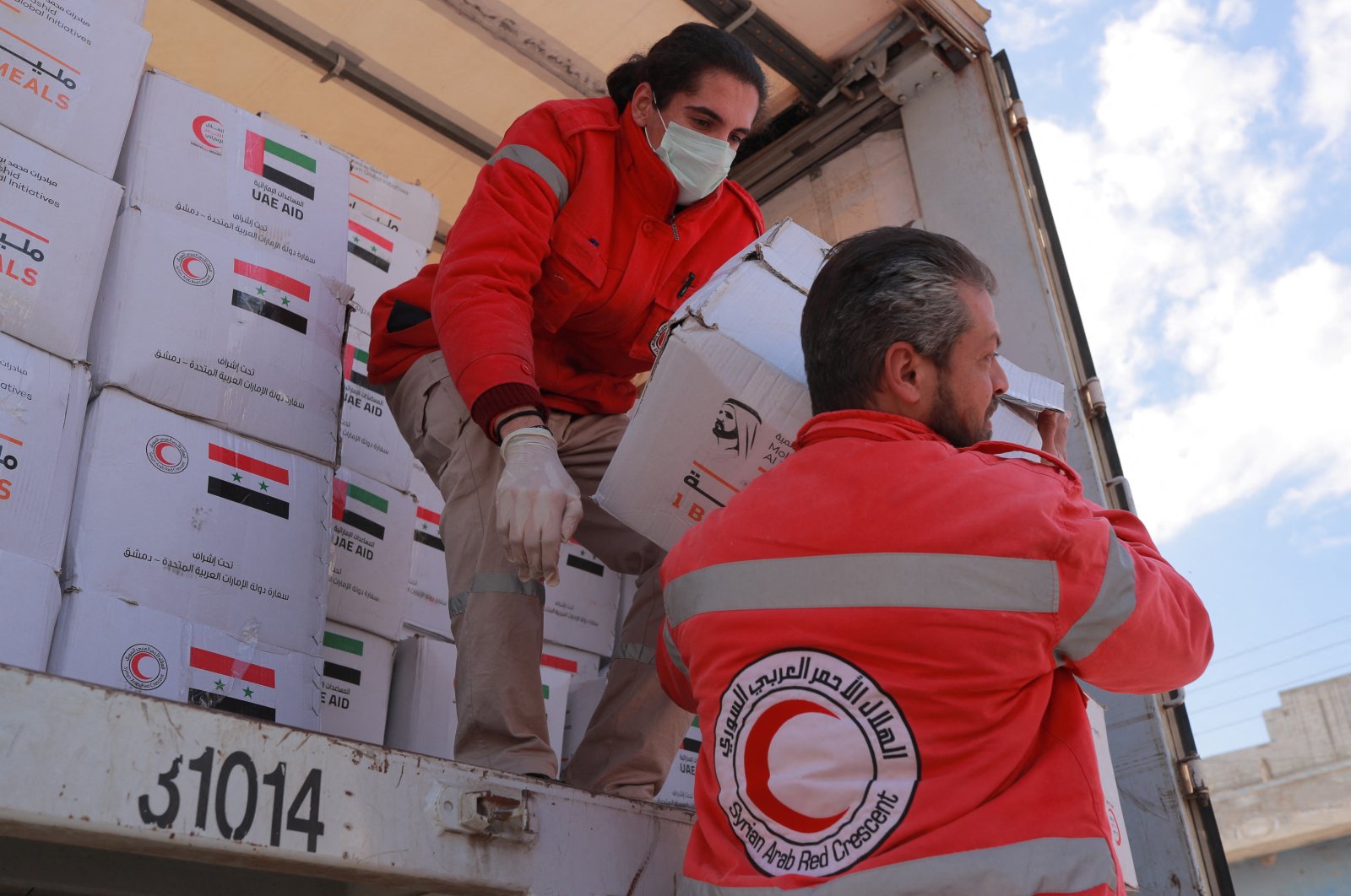 Syrian Arab Red Crescent personnel carry boxes of aid offered by the United Arab Emirates in response to a deadly earthquake, in Latakia, Syria, Feb. 15, 2023. (Reuters Photo)