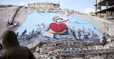 Syrian artists, who met in the town of quake-ravaged Jindires, painted the suffering of the people on the wall of a destroyed building, Afrin, Syria, Feb. 22. 2023. (AA Photo)