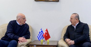 Greek Foreign Minister Nikos Dendias (L) is welcomed by his Turkish counterpart Mevlüt Çavuşoğlu following the deadly earthquake, in Adana, Türkiye, Feb.12, 2023. (Reuters Photo)