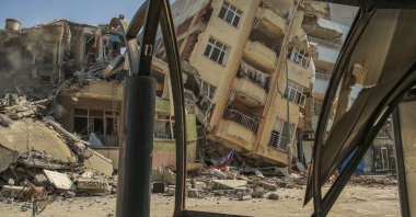 A destroyed building leans on a neighboring house following the earthquake in Samandağ, Hatay, southern Türkiye, Feb. 22, 2023. (AP Photo)