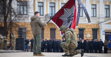 President Volodymyr Zelenskyy bestows a flag to a soldier at a ceremony in Kyiv, Ukraine, Feb. 24, 2022. (AA Photo)