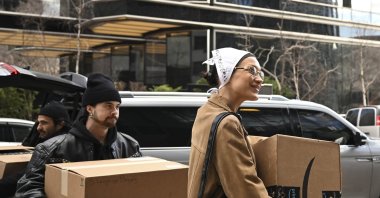 Supermodel Bella Hadid smiles as she carries a box filled with humanitarian aid supplies for Turkish earthquake survivors in New York, U.S., Feb. 24, 2023. (AA Photo)