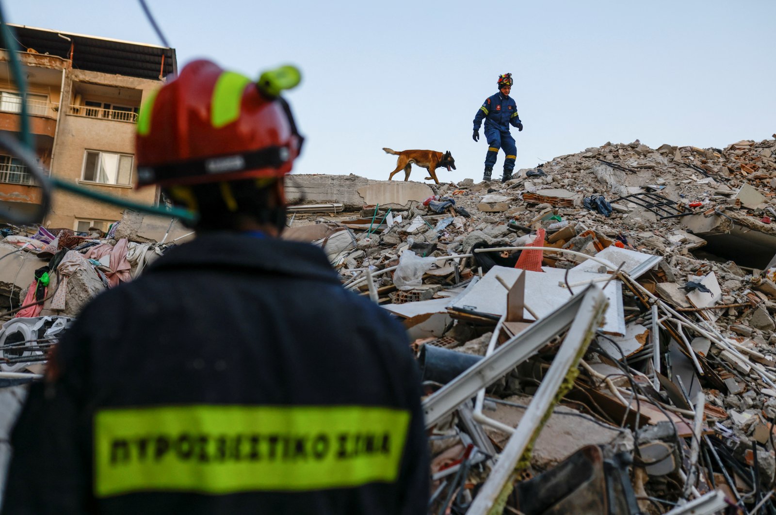 Members of a Greek rescue team work on the site of a collapsed building, as the search for survivors continues, in the aftermath of a deadly earthquake, in Hatay, Türkiye, Feb. 11, 2023. (Reuters Photo)