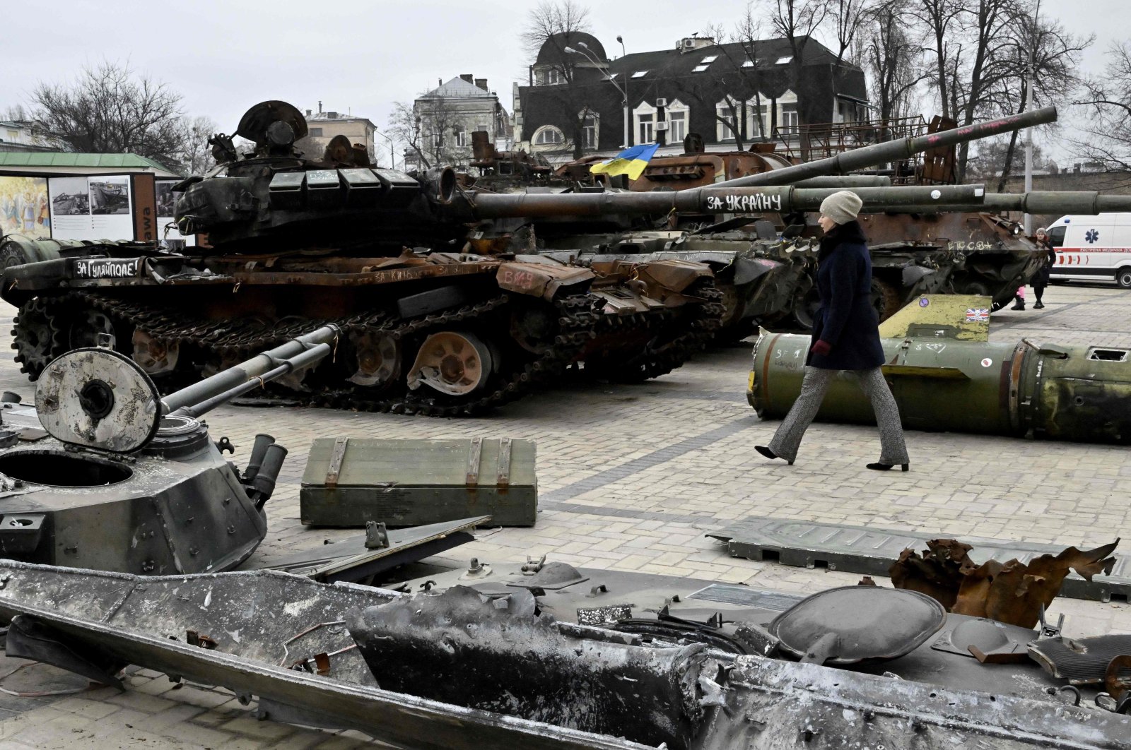 A woman walks past destroyed Russian military vehicles shown in an open-air exhibition in the center of Kyiv, Ukraine, Feb. 24, 2023. (AFP Photo)