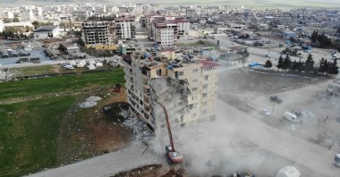 Construction vehicles demolish a heavily damaged building in the Nurdağı district in Gaziantep, Feb. 25, 2023. (IHA Photo)