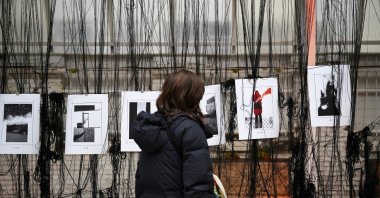 A person looks on an artwork at the Art Weapon Festival created during the Russian invasion of Ukraine at the &quot;Alte Muenze,&quot; Berlin, Germany, Feb. 25, 2023. (Reuters Photo)