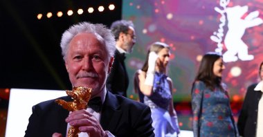 Director Nicolas Philibert poses with a Golden Bear for best film for &quot;On the Adamant&quot; at the awards ceremony at the 73rd Berlinale International Film Festival in Berlin, Germany, Feb. 25, 2023. (Reuters Photo)