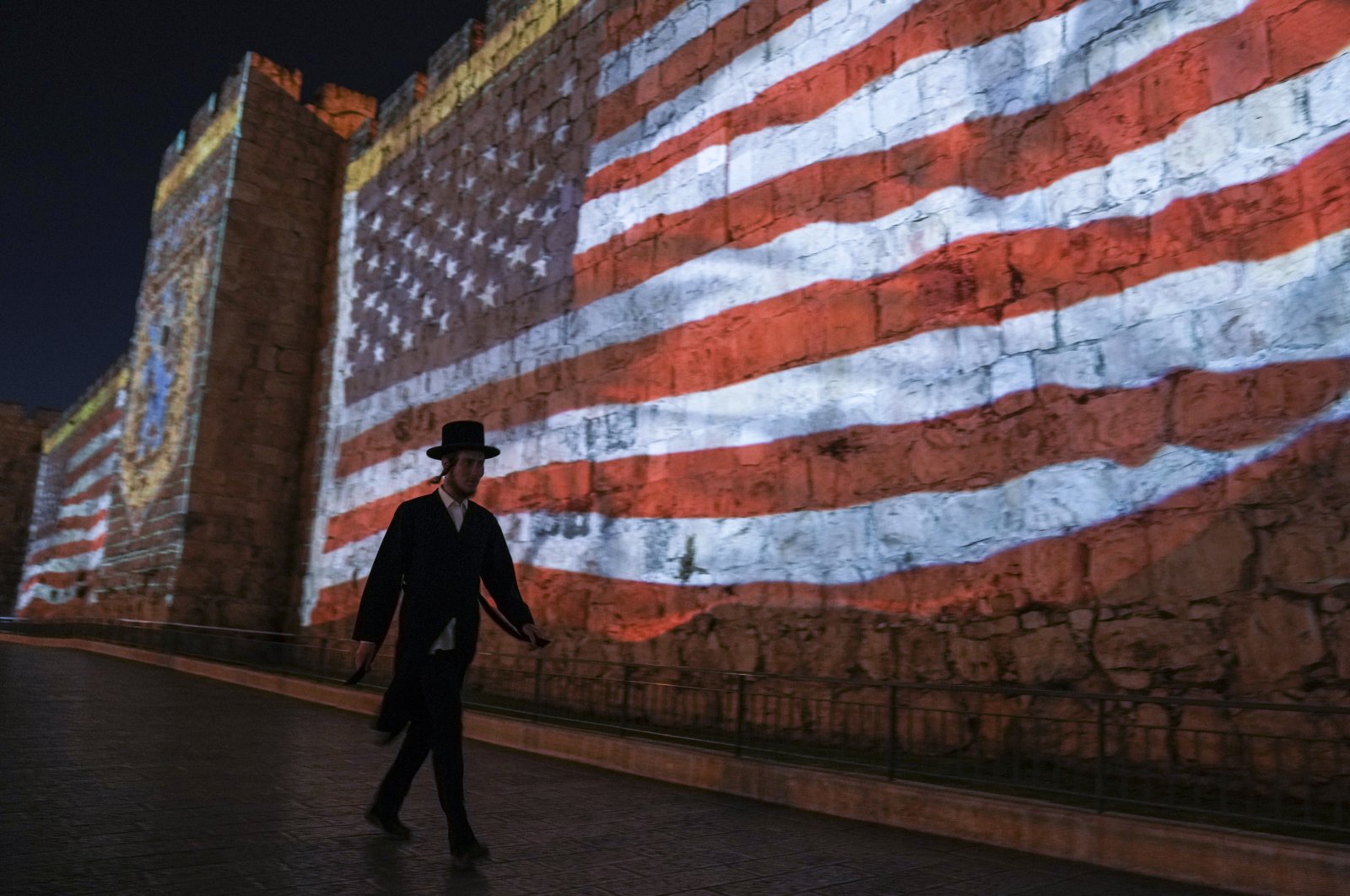 An image of the U.S. flag is projected on the walls of Jerusalem&#039;s Old City in honor of President Joe Biden&#039;s visit to Jerusalem, July 13, 2022. (AP Photo)