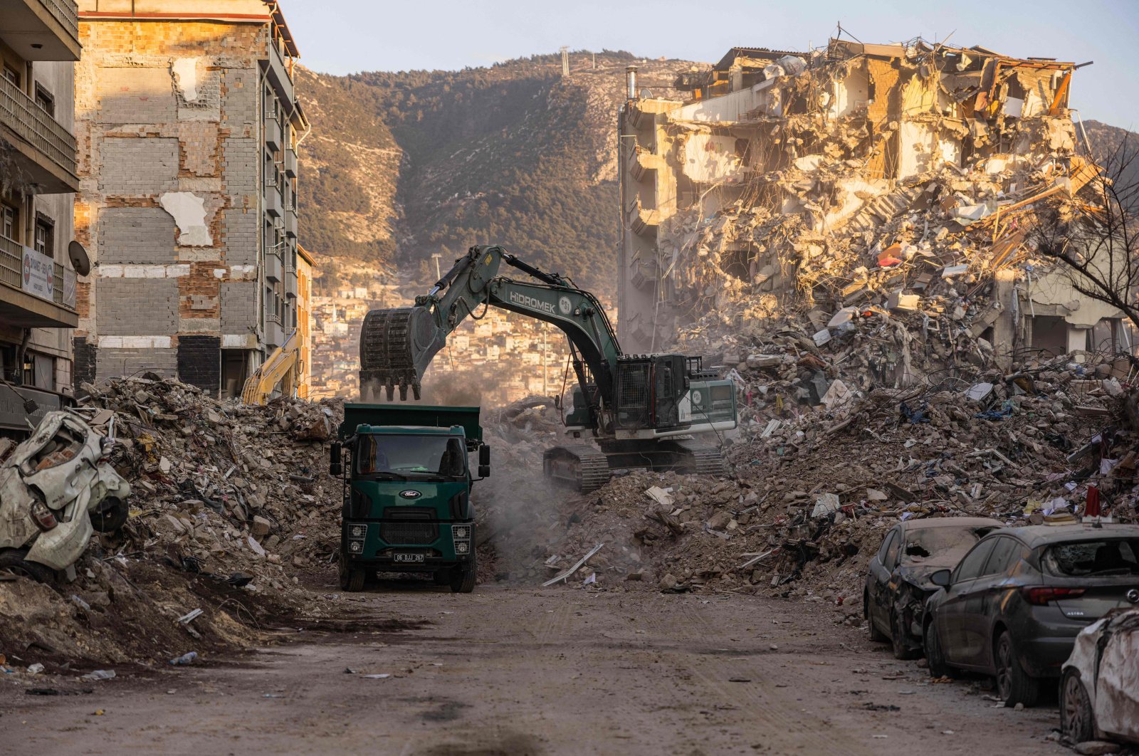 A digger removes the rubble of collapsed buildings following the deadly earthquakes in Antakya, Hatay province, southern Türkiye, Feb. 20, 2023. (AFP Photo)