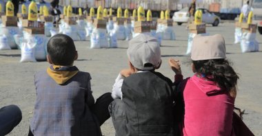 Yemeni children wait to receive their families' food aid in Sanaa, Yemen, Feb. 26, 2023. (EPA Photo)