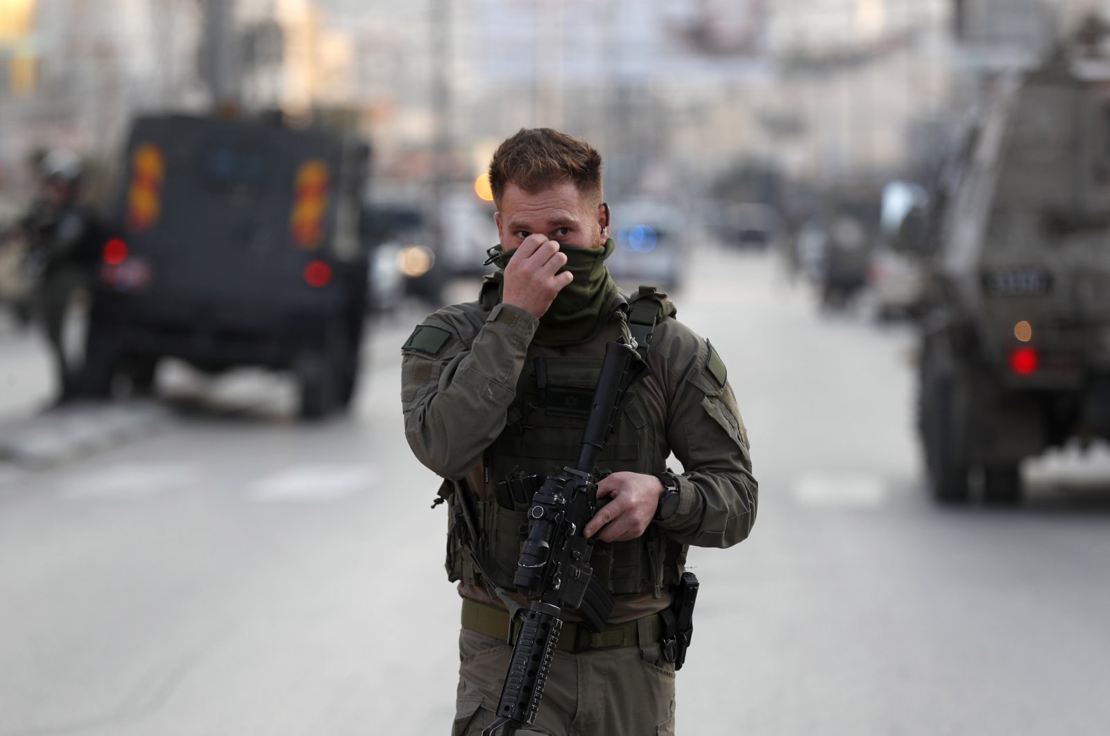 An armed Israeli soldier stands near the scene of a shooting attack, Hawara, occupied West Bank, Palestine, Feb. 26, 2023. (EPA Photo)