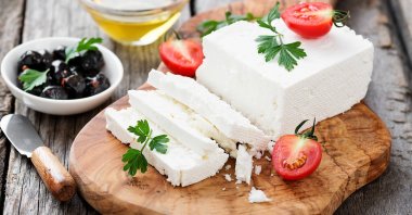 Sliced feta cheese with herbs and olive oil. (Shutterstock Photo)