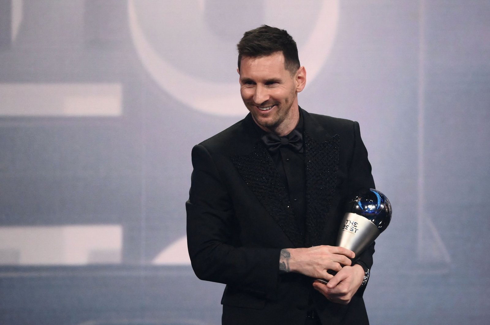 Argentina and Paris Saint-Germain forward Lionel Messi poses on stage after receiving the Best FIFA Men Player award during the Best FIFA Football Awards 2022 ceremony, Paris, France, Feb. 27, 2023. (AFP Photo)