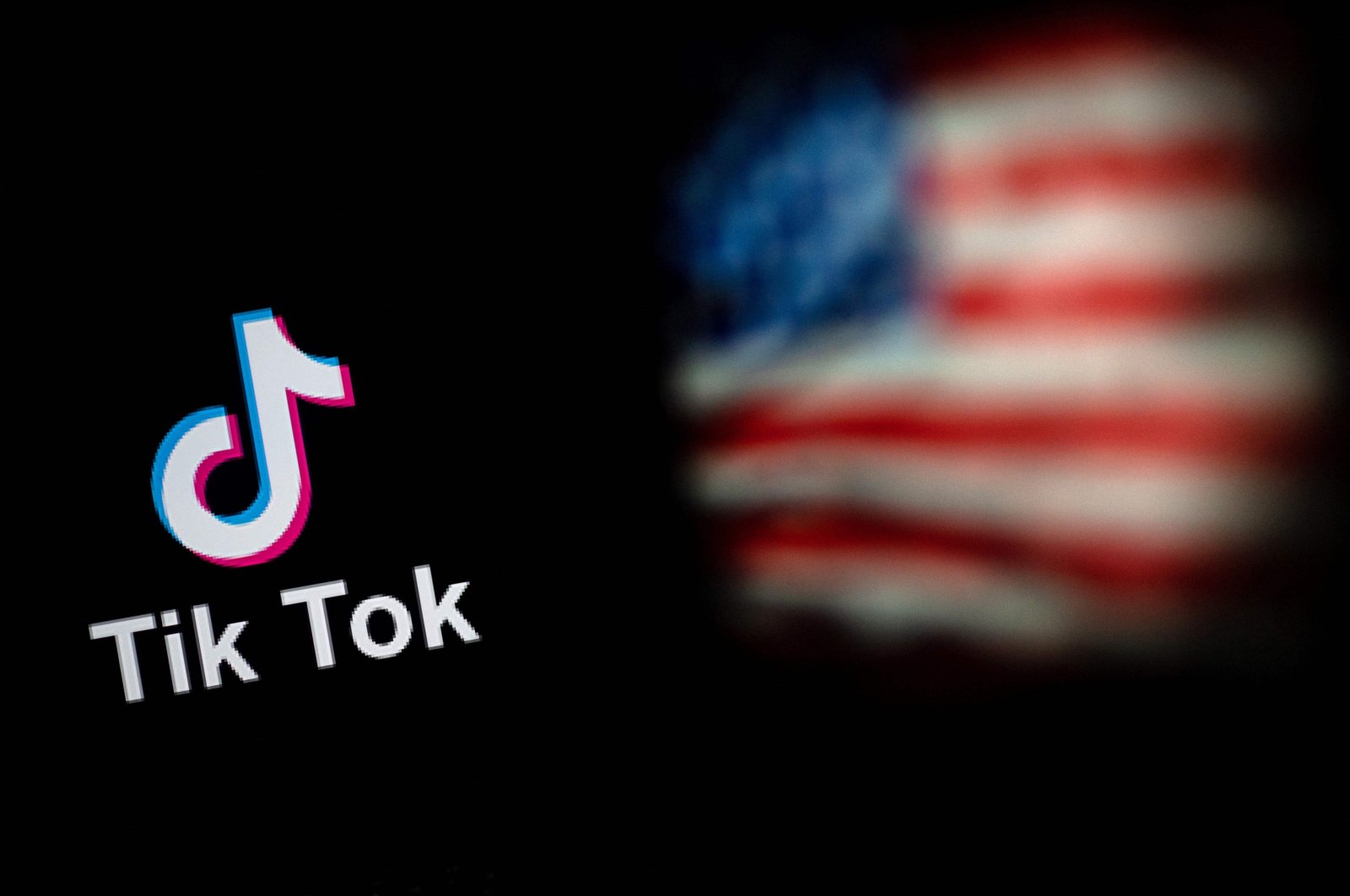 The logo of the social network application TikTok and the U.S. flag are seen on the screens of two laptops in Beijing, China, Sept. 14, 2020. (AFP Photo)