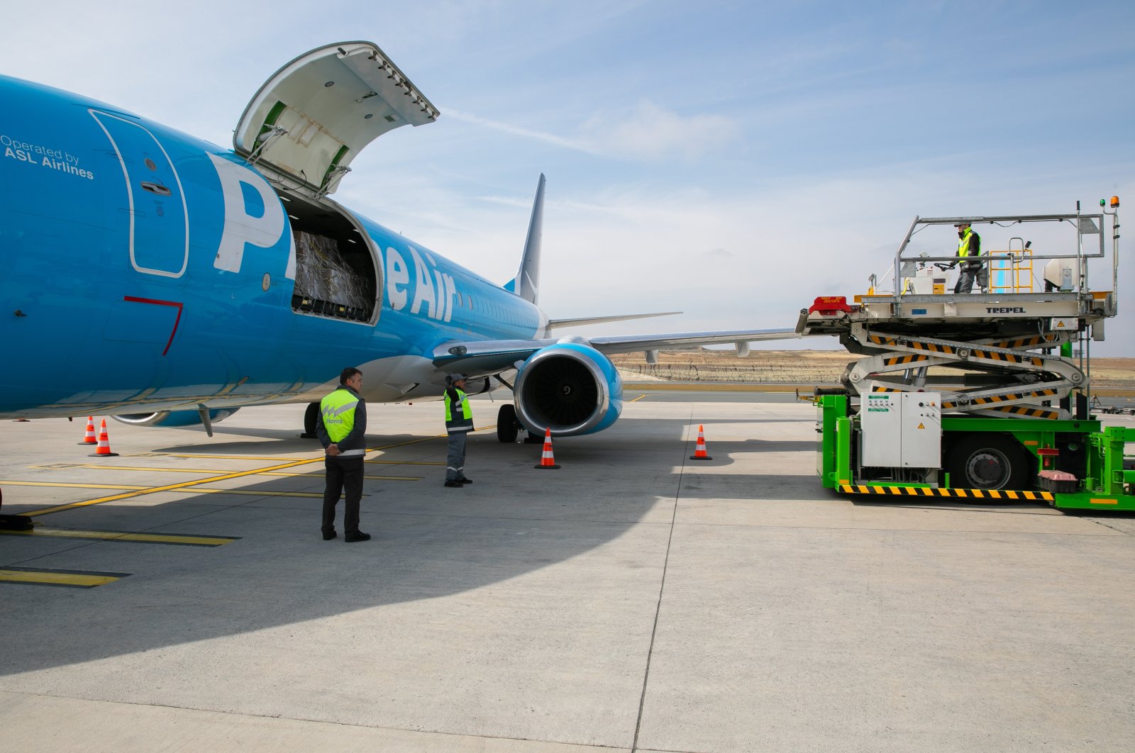 An Amazon Air cargo plane is being loaded with disaster relief supplies in an unspecified location. (Courtesy of Amazon)
