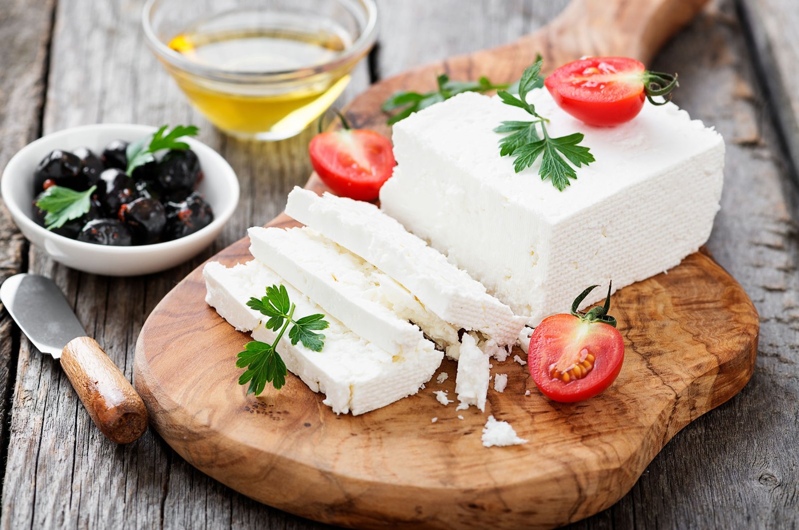 Sliced feta cheese with herbs and olive oil. (Shutterstock Photo)