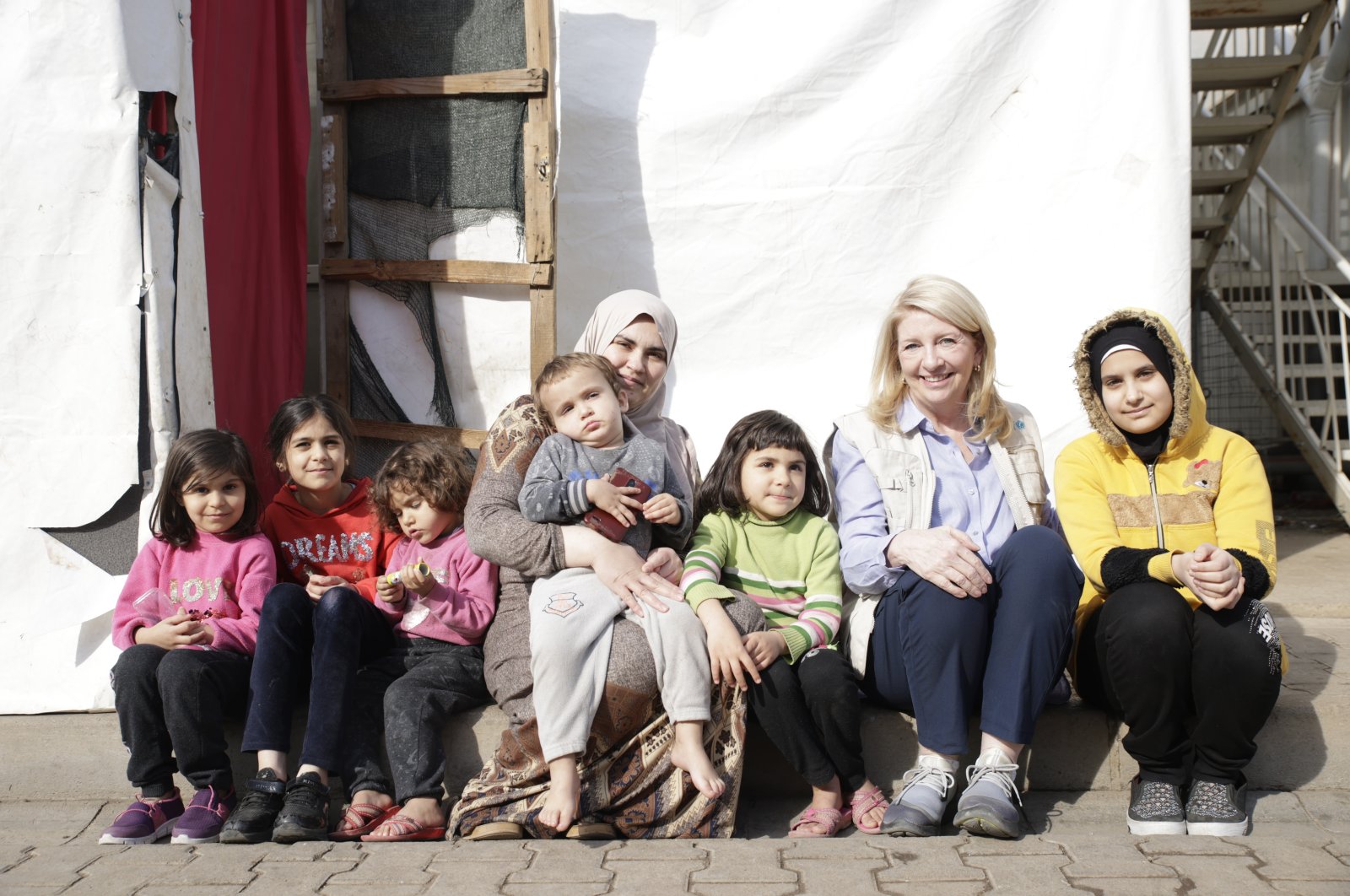 UNICEF Director-General Catherine Russell (2nd R) is photographed together with a family who survived the devastating Feb. 6 twin earthquakes, Kahramanmaraş, southeastern Türkiye. (Courtesy of UNICEF)
