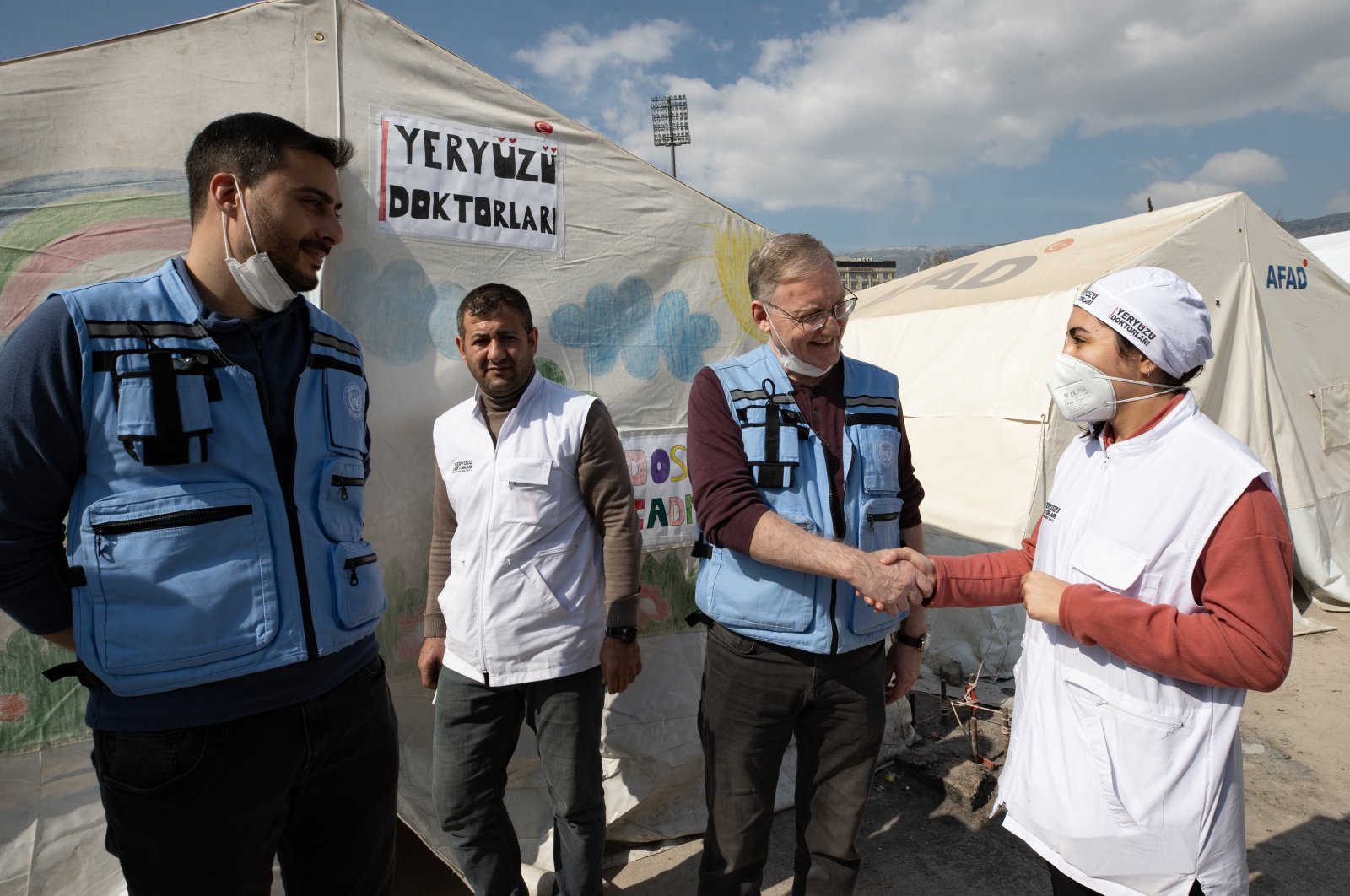 The U.N. resident coordinator to Türkiye Alvaro Rodriguez (C) shakes hands with the officials of a tent city in Kahramanmaraş, Türkiye, Feb. 23, 2023. (AA Photo)