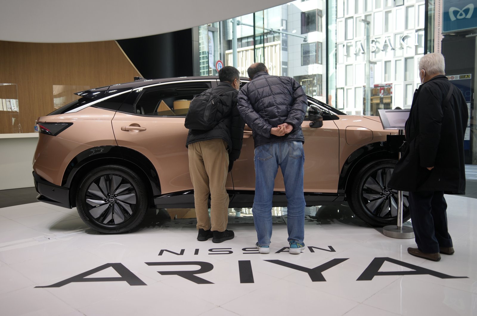 Visitors inspect an Ariya, Nissan&#039;s first all-electric crossover SUV, at a Nissan showroom in Tokyo, Japan, Feb. 6, 2023. (EPA File Photo)