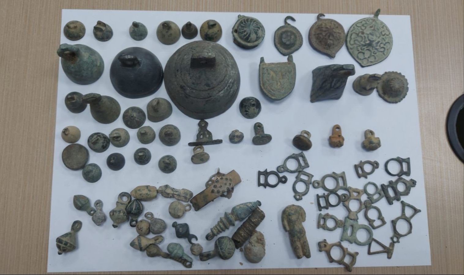 Artifacts, including 64 objects, 20 coins, 7 seals, 1 statue and other objects, were seized in Izmir, March 1, 2023. (IHA Photo)