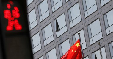 A Chinese national flag flutters outside the China Securities Regulatory Commission (CSRC) building on the Financial Street in Beijing, China, July 9, 2021. (Reuters Photo)