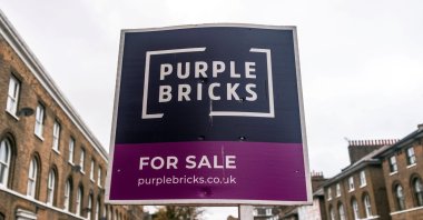 A sign for online estate agent Purplebricks outside a property in a residential street in London, Britain, Nov. 24, 2021. (Reuters Photo)