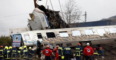  Crane vehicles try to remove pieces of damaged train wagon after a collision near Larissa city, Greece, March 1, 2023. (EPA Photo)