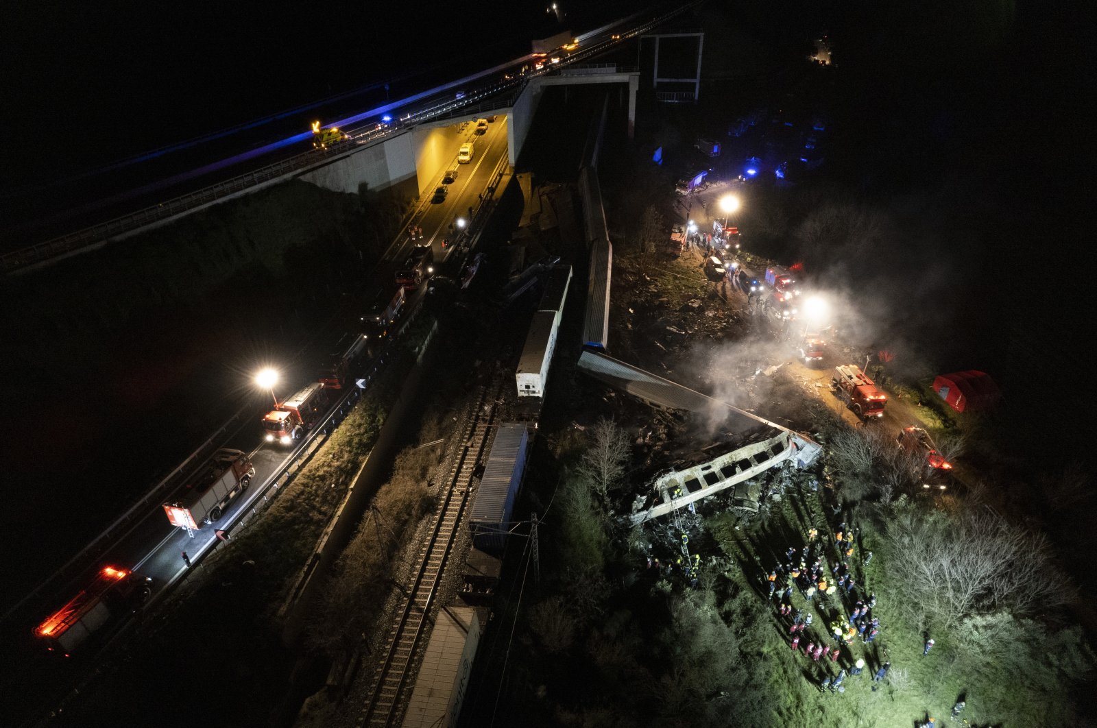 Firefighters and rescue crews working to extricate passengers from trains after a collision near Larissa, Greece, March 1, 2023. (EPA Photo)