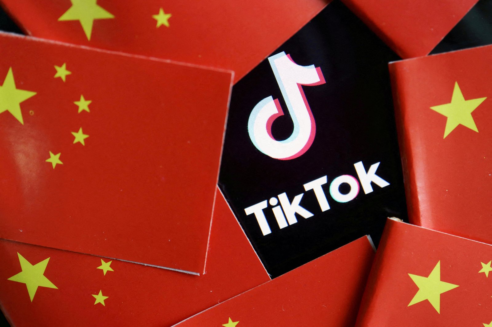 China&#039;s flags are seen near a TikTok logo in this illustration picture taken July 16, 2020. (Reuters Photo)